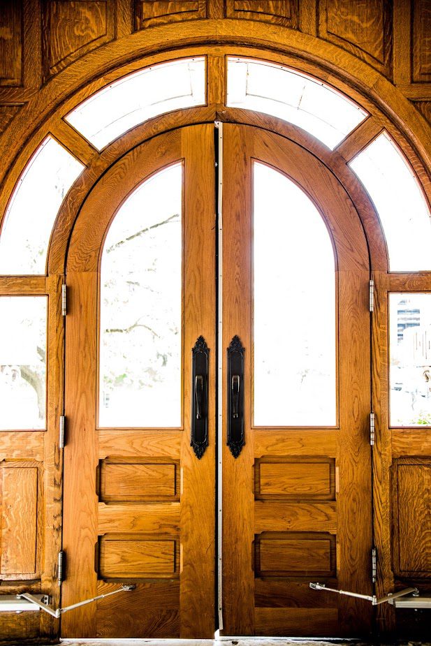 golden wooden door with arch-top windows